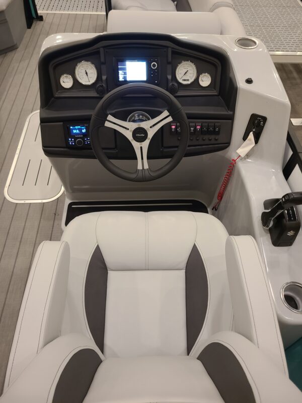 A boat with the steering wheel and dashboard in it.