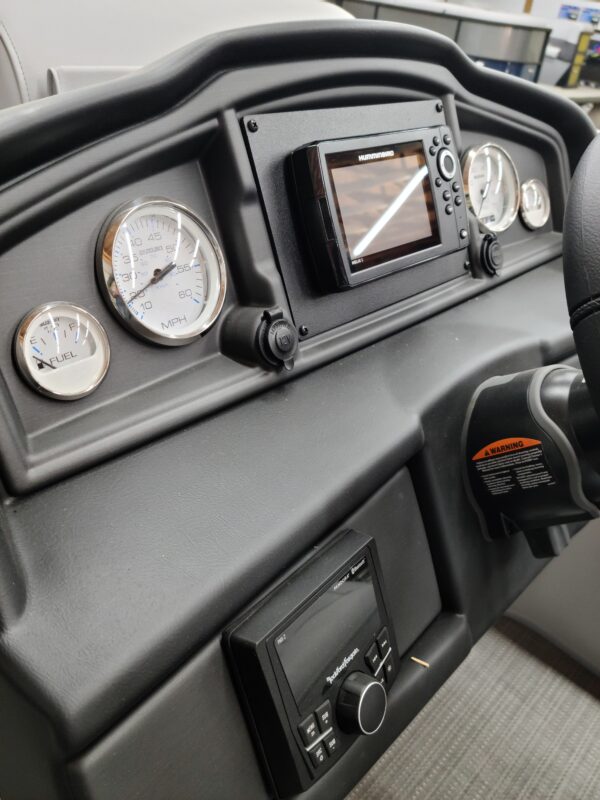 A dashboard of an automobile with several gauges.