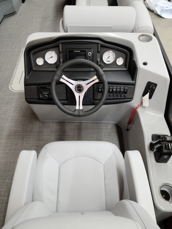 A boat with the steering wheel and dashboard in it.