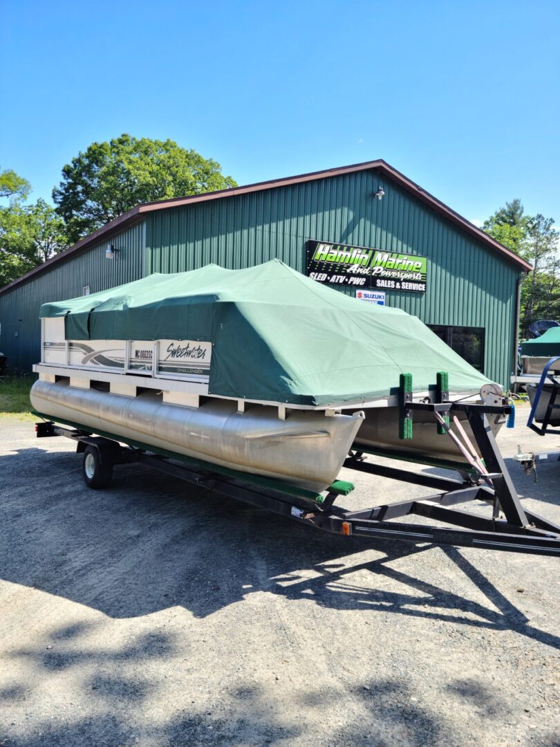 A boat is parked in front of a building.