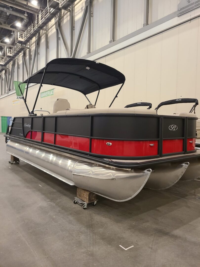 A boat is parked in the middle of a warehouse.