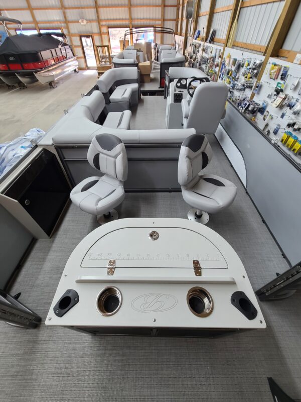 A boat with two seats and a table in the back.