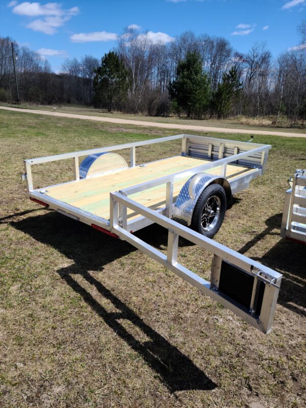 A trailer with the side rails down and the back of it.