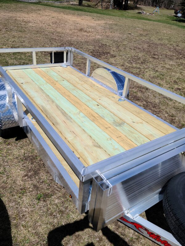 A trailer with wood planks on the top of it.