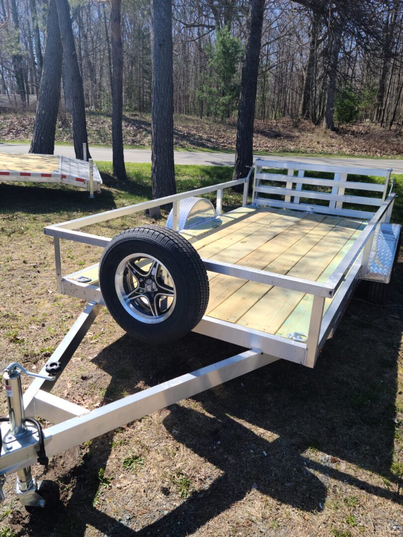 A trailer with a tire on it in the grass.