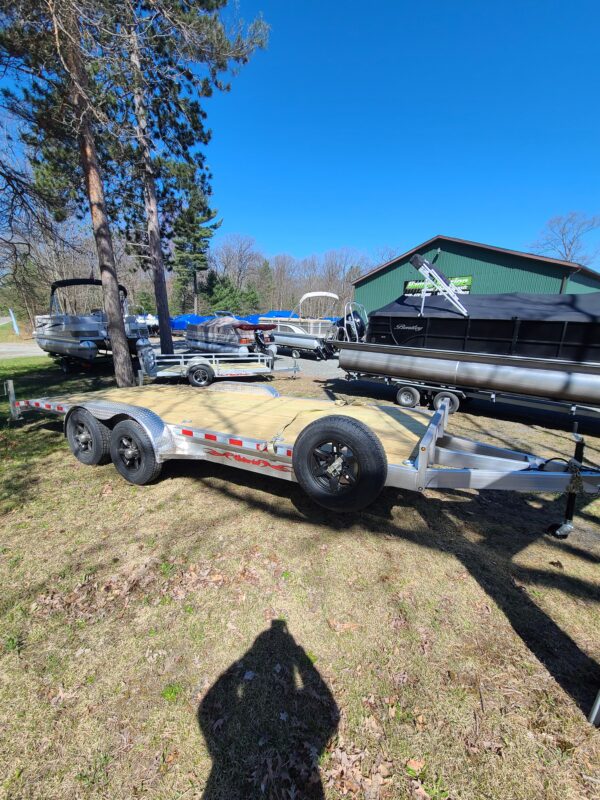 A trailer that is parked in the grass.