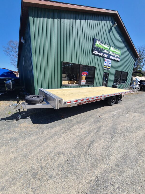 A green building with a trailer in front of it