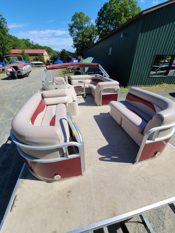 A boat with two couches and one table in the back.