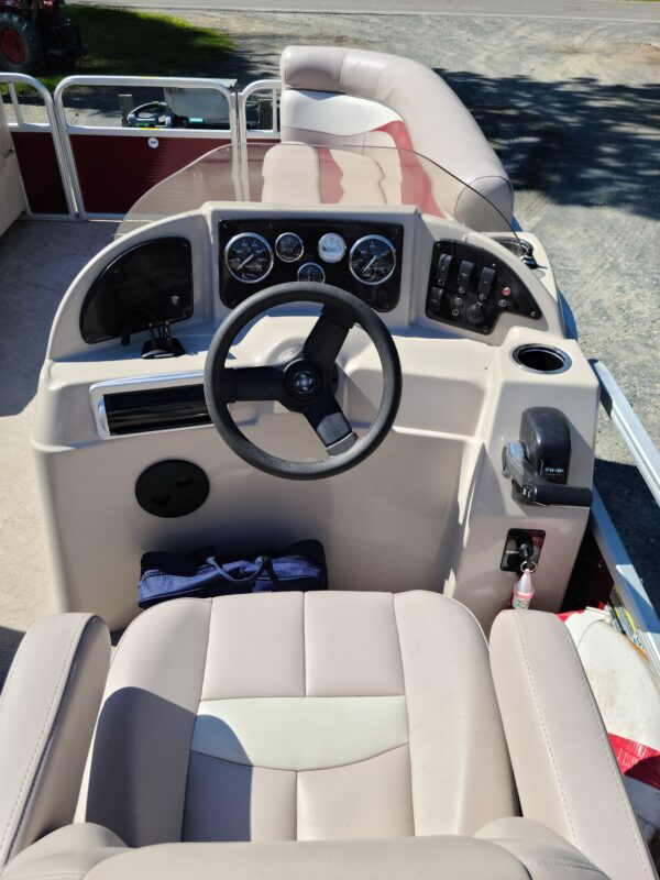 A boat with the steering wheel and dashboard in it.