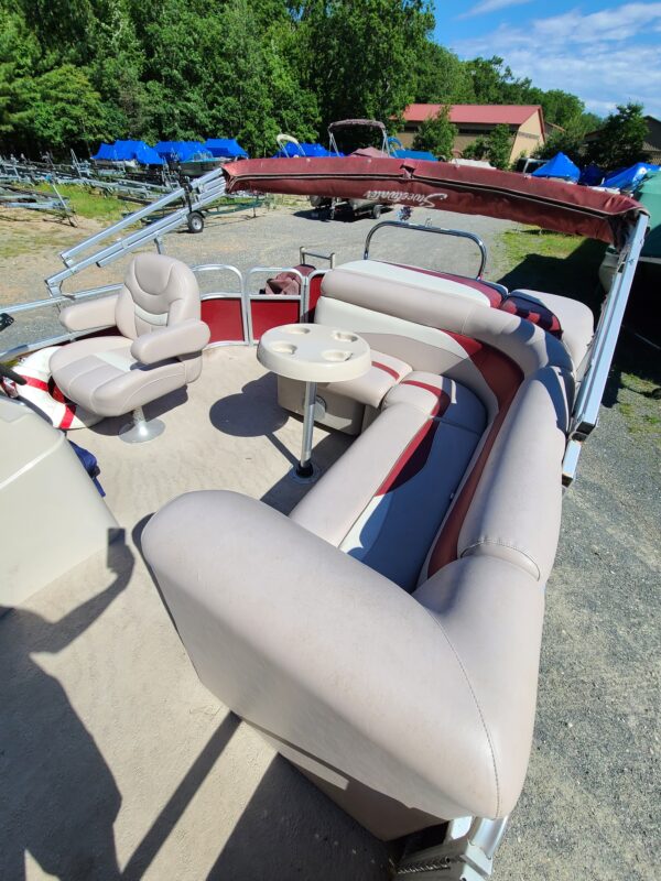 A boat with several seats and tables on it.