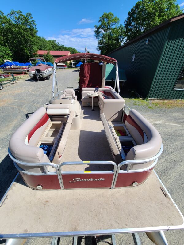 A boat is parked in the middle of a lot.