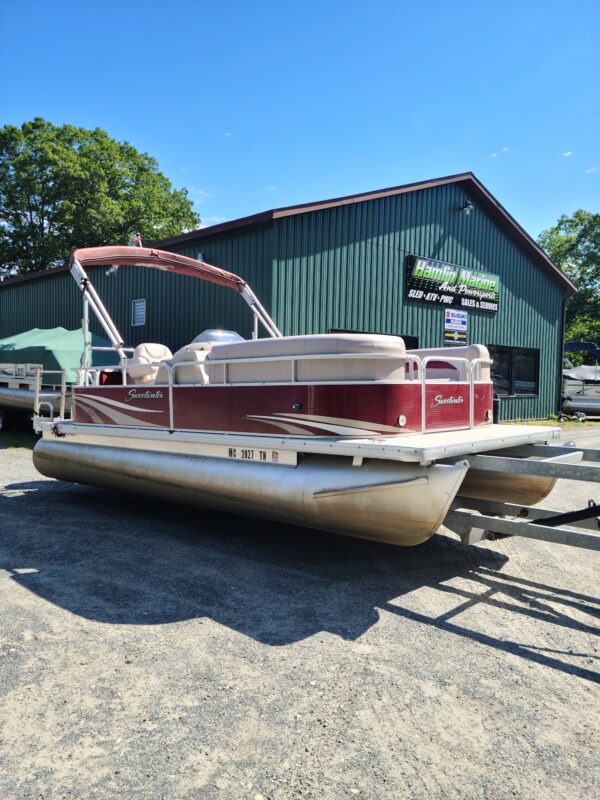 A boat is parked in front of a building.