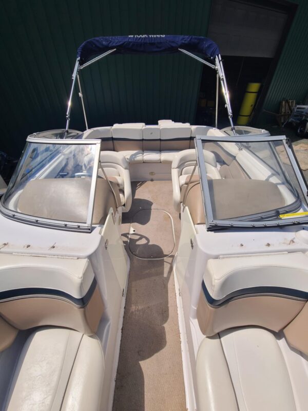 A boat with two seats and a windshield.