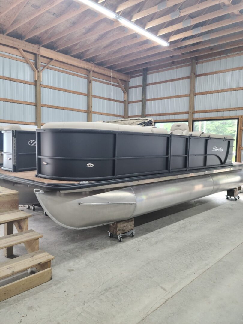 A boat in a warehouse with many other boats.