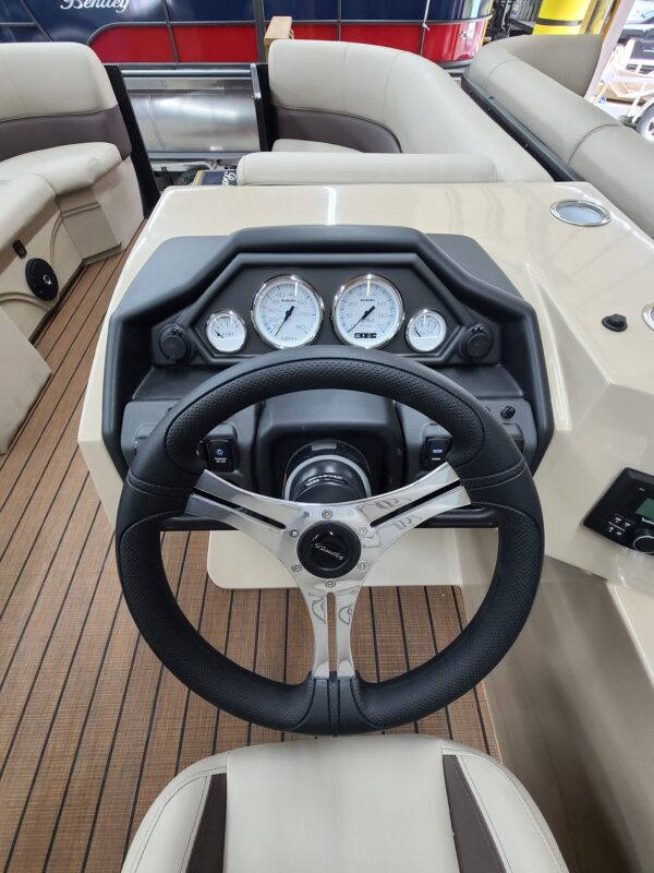 A boat with steering wheel and dashboard on the deck.