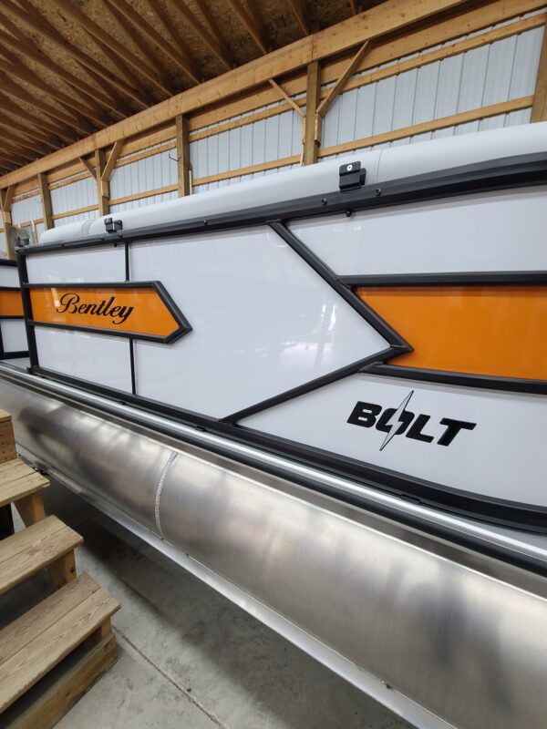 A large white and orange boat with the words " building " on it.