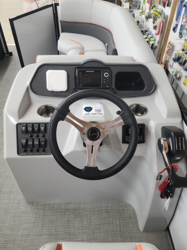 A boat with steering wheel and controls on the front.