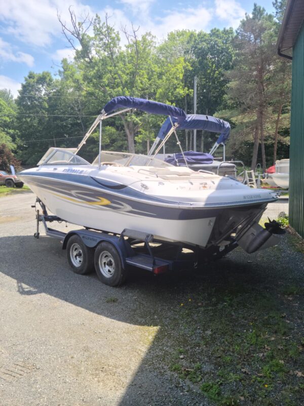 A boat is parked on the side of the road.