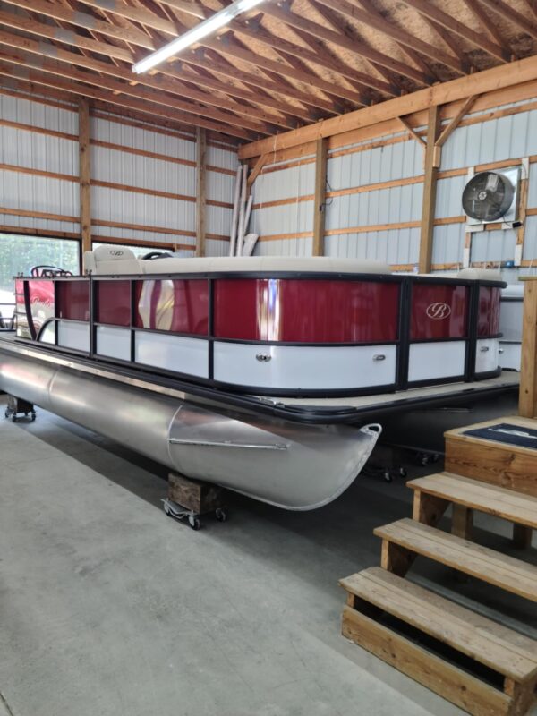 A boat is parked in the garage of a building.