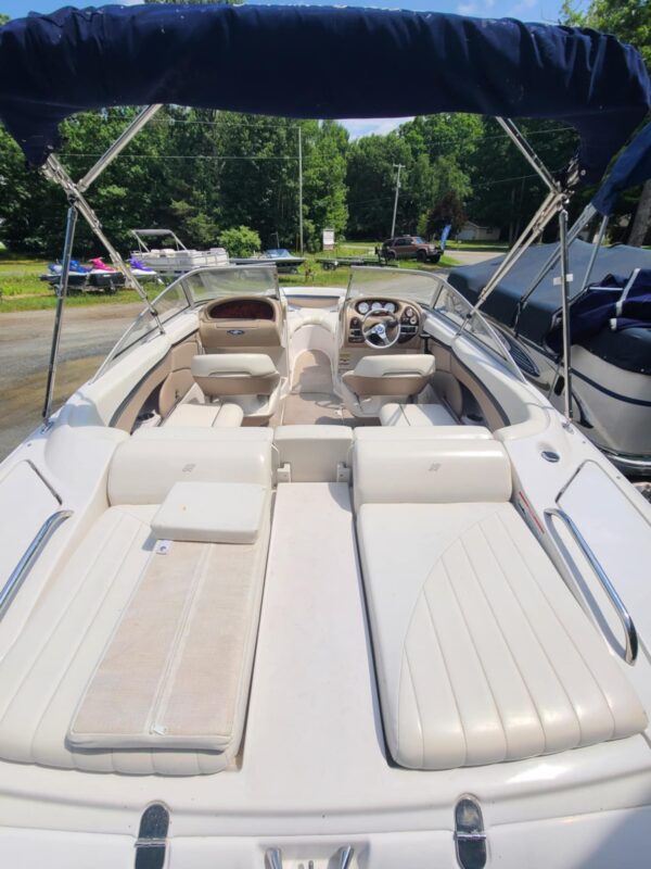 A boat with two seats and a steering wheel.