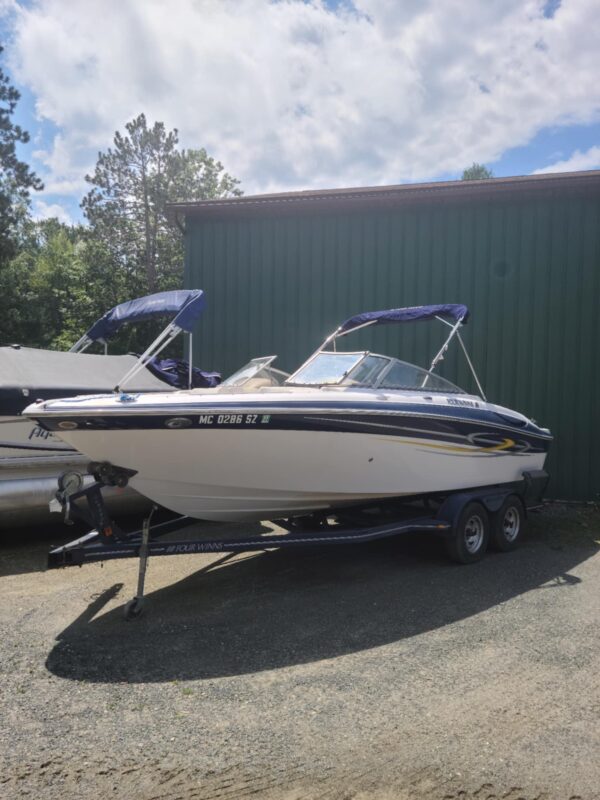 A boat parked in the back of a trailer.