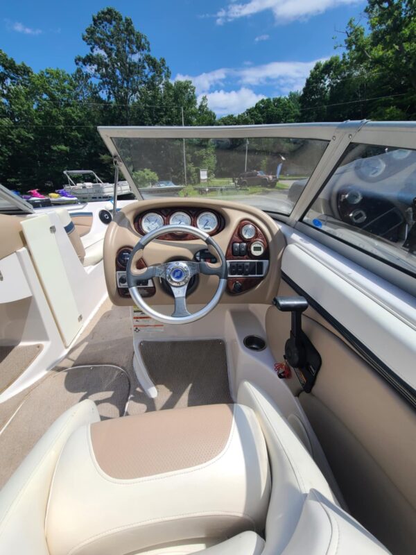 A boat with the steering wheel and dashboard in it.