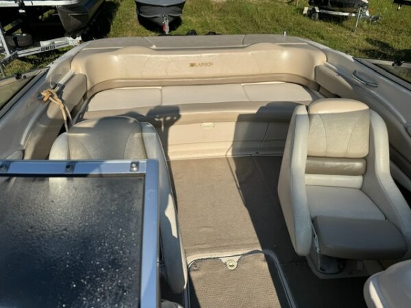 A boat with two seats and a table in the back.