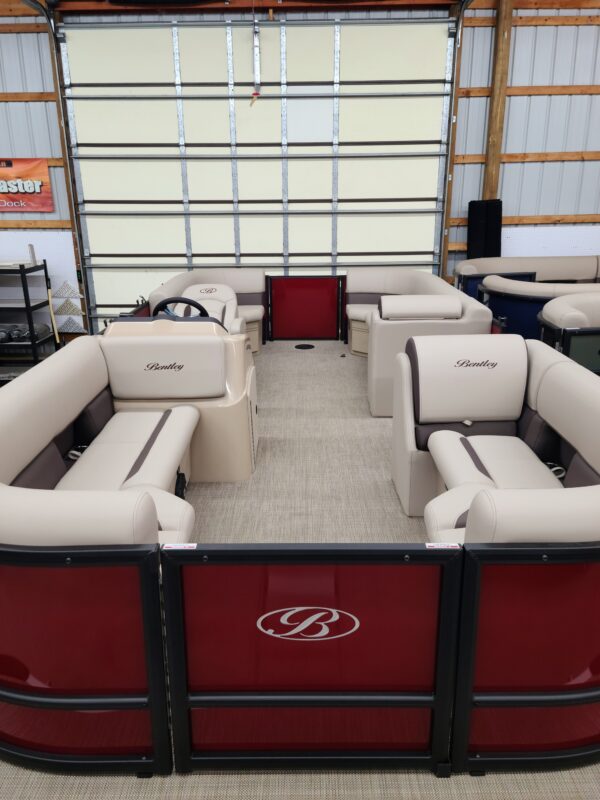 A red and white boat with two couches in it.